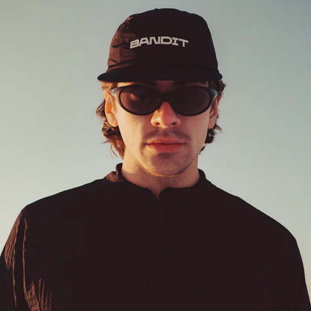 Man in sunglasses wearing a black Bandit Running cap with the Blocked Bandit logo